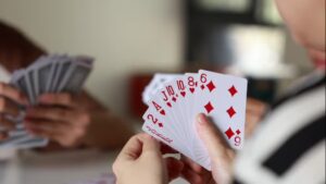 Hand of cards being arranged during a 13 card indian rummy game