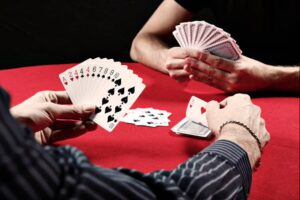 Two hands of gin rummy cards facing each other