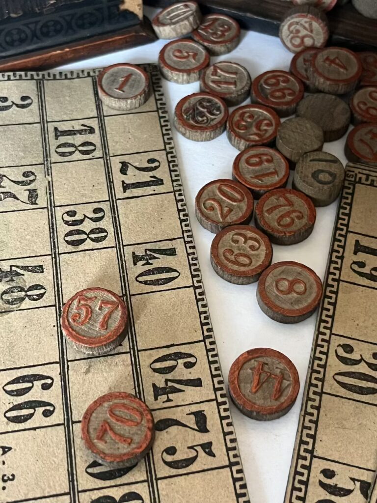 Vintage bingo cards with numbered wooden tokens