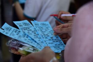 People holding bingo cards during a bingo game